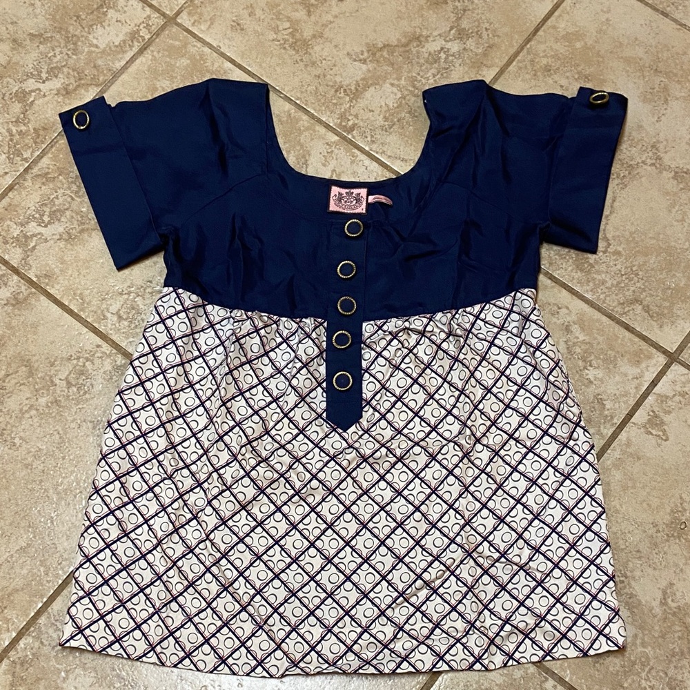Juicy Couture 100% silk short-sleeve blouse with a patterned design.